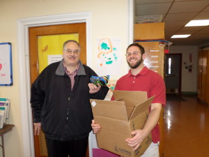 Dan Ress (right) receives clothing donation from Pastor Mark Wildermuth of Faith Lutheran Church